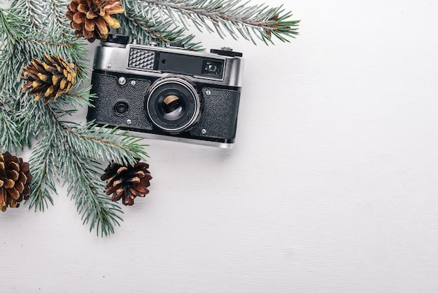 Camera Christmas wooden background New Year's holiday Christmas motive On a wooden surface Top view Free space for your text