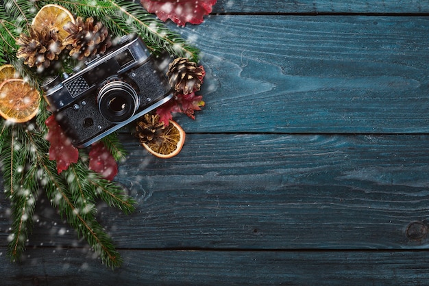 Camera Christmas wooden background New Year's holiday Christmas motive On a wooden surface Top view Free space for your text