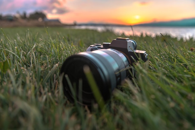 Camera on the grass at the sunset