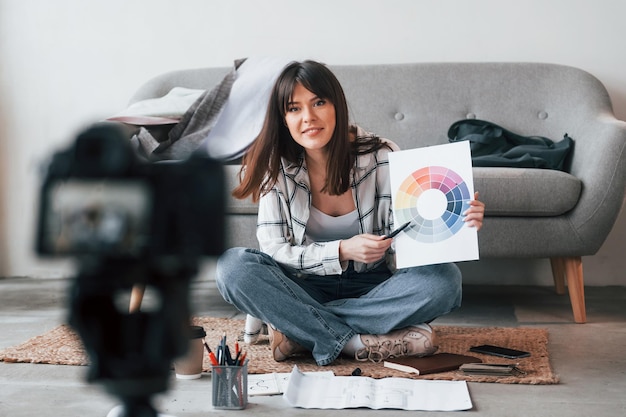 Camera is on the floor Young female freelance worker is indoors in home at daytime