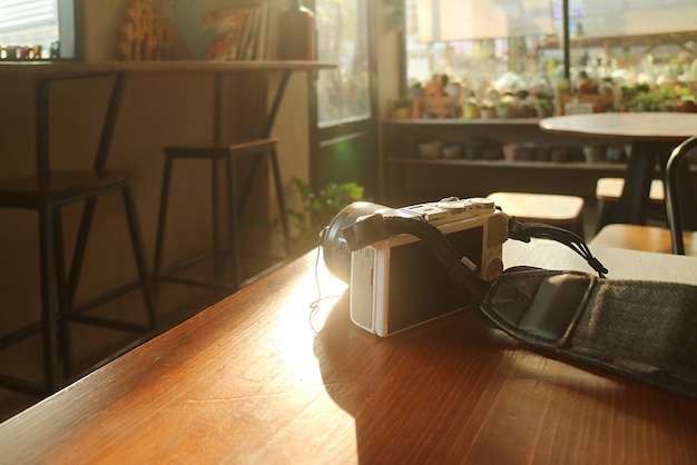 Camera isolated on wooden table in an empty room