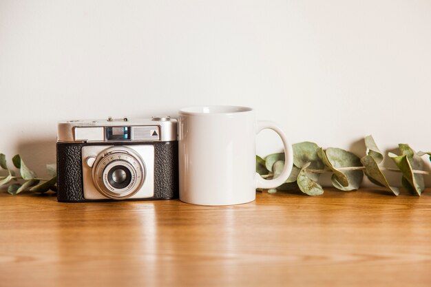 Camera next to mug