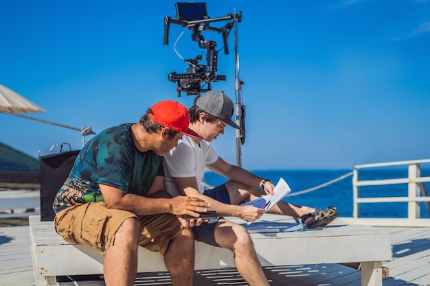 Photo camera operator and director discuss the process of a commercial video shoot