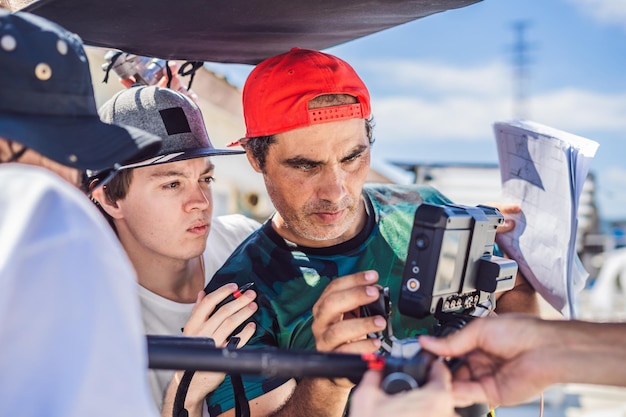 Camera operator director and dp discuss the process of a commercial video shoot