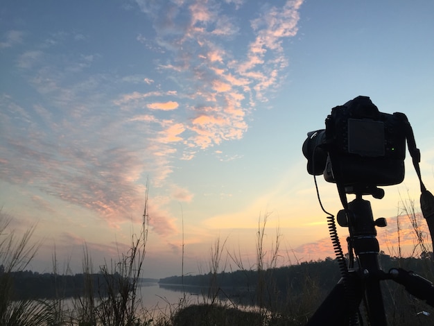 Photo camera and sunrise.