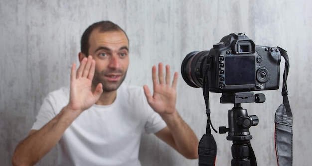 Camera on tripod is filming a man Blogger