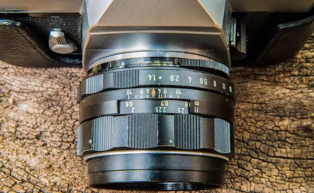 Photo camera on wooden background