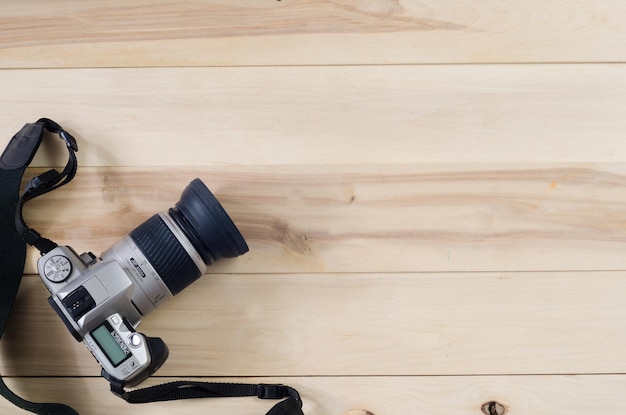 Camera on wooden background