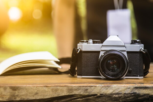 camera on wooden table outdoors garden background