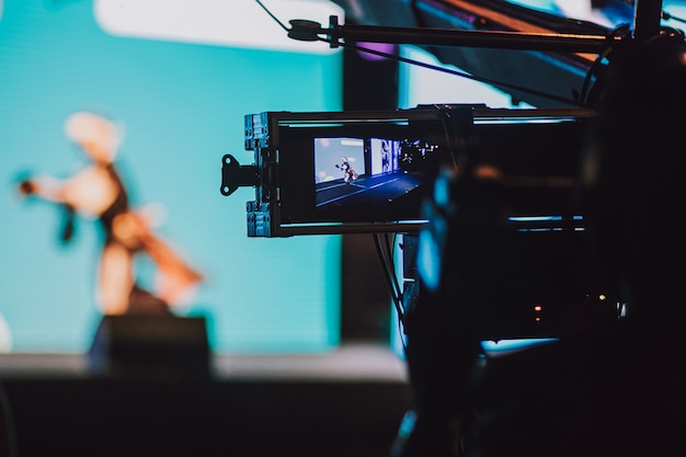 Cameraman filming evening entertainment with professional camera