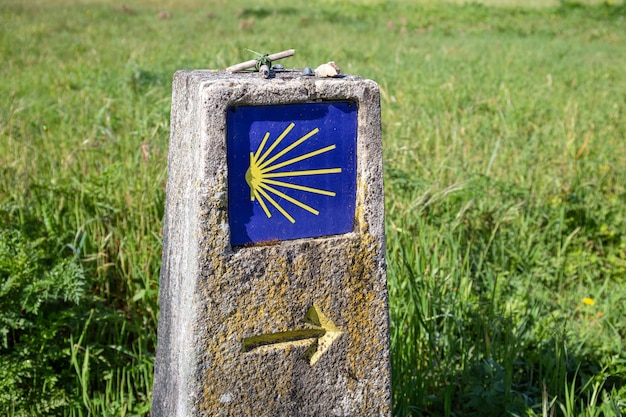 Camino de Santiago sign Pilgrimage to Santiago de Compostela concept Way of Saint James shell sign and yellow arrow