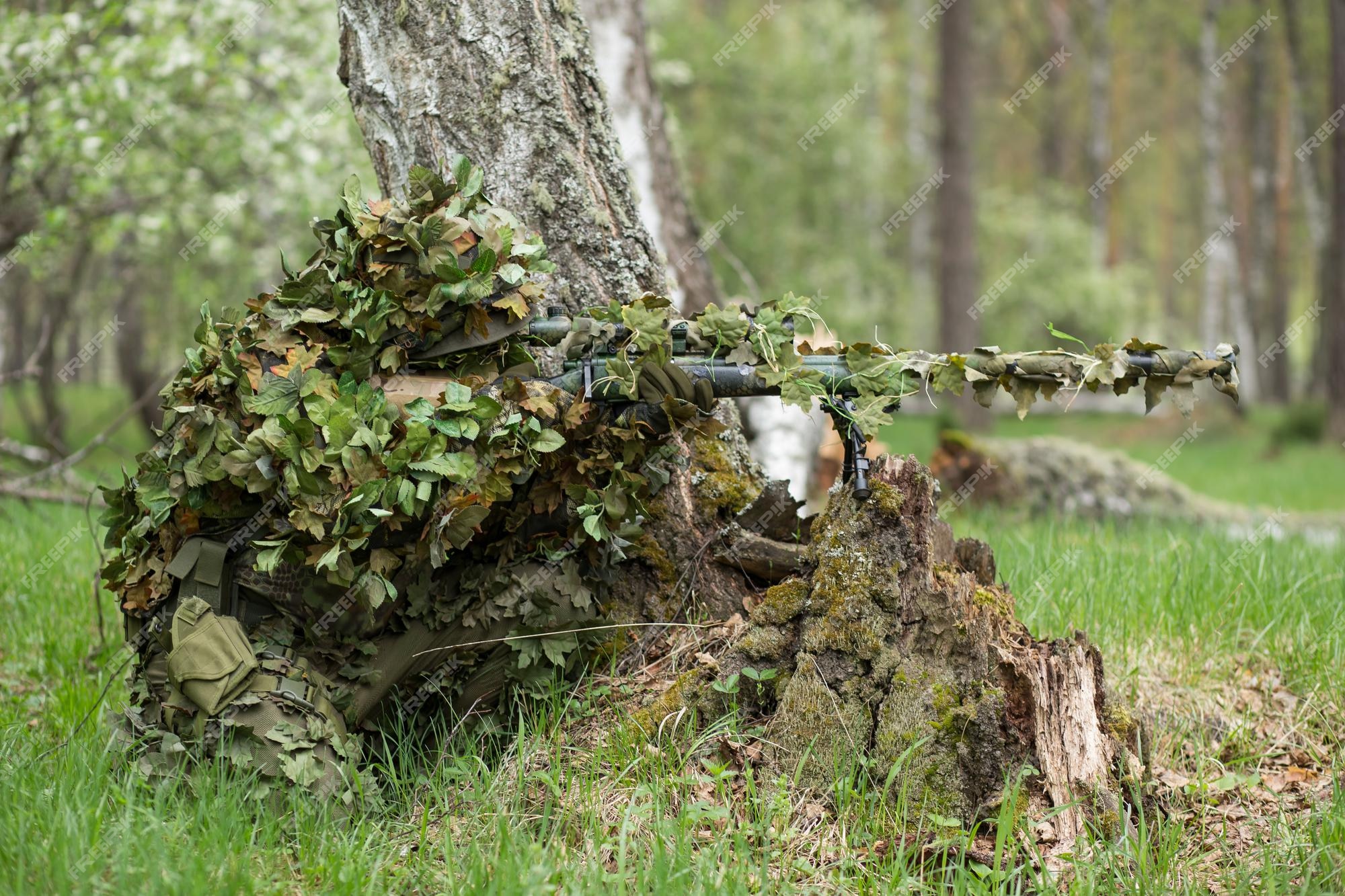 Premium Photo  Camouflaged sniper in the forest in ambush. military man  aiming a gun, a rifle at the enemy in nature