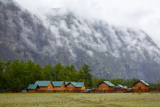 Camp at foot of cliff covered in fog