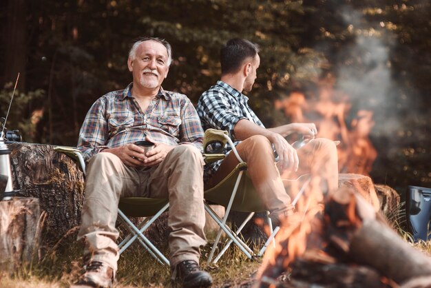 Camp with bonfire in woodland