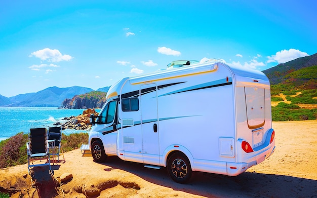 Camper on road at Capo Pecora at Mediterranean sea in Sardinia Island, Italy summer. Caravan motorhome on holidays at highway. Minivan rv on motorway. Cagliari. Mixed media.