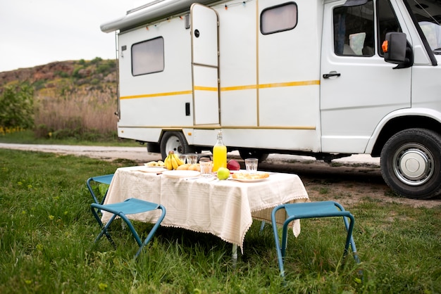 Campervan and table with food arrangement
