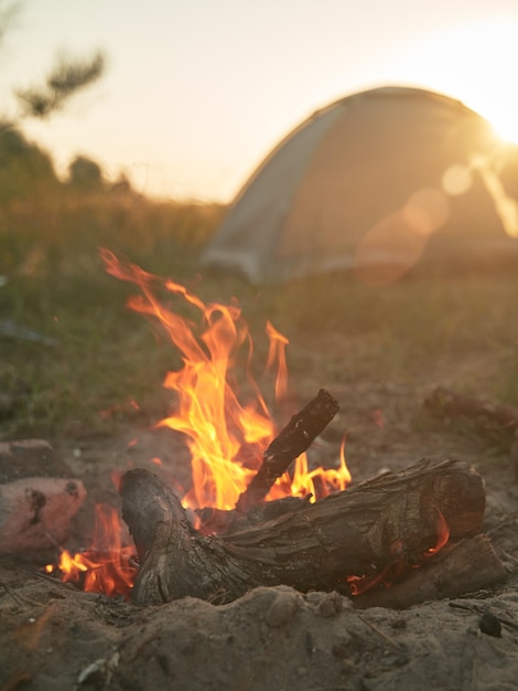 Campfire in front of tent weekend out of a town warm place