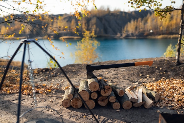 campfire with wooden logs and ax