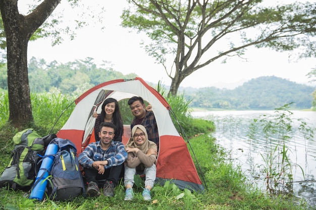 Camping by a lake with friends