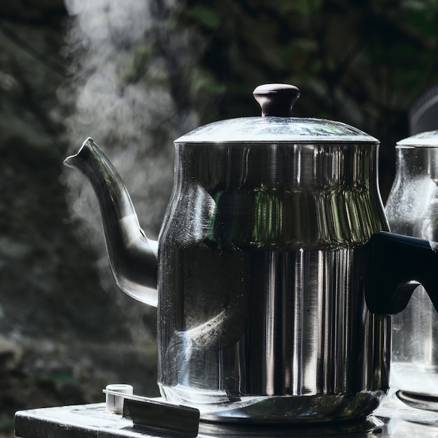 Photo camping camp holidays concept. two teapots with hot tea