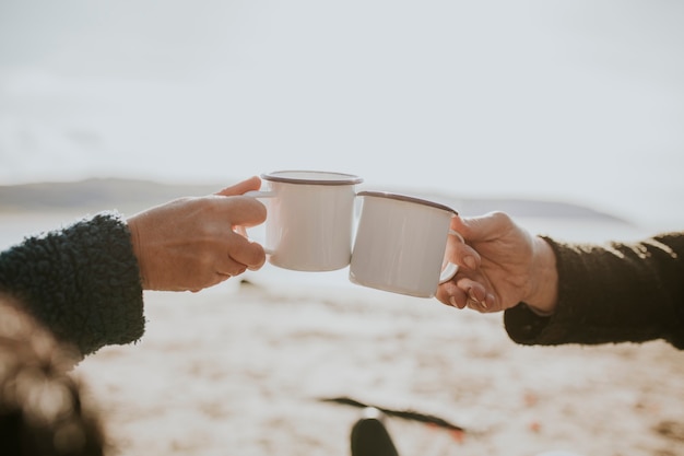 Camping couple having coffee in the morning