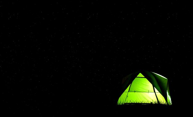 Camping green tent in forest at night and star background