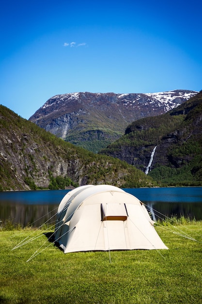 Camping. Holiday in Norway. Tourist tent on the shore of the lake.