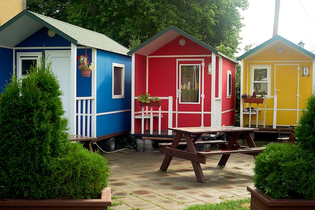 Camping in natureSmall multicolored houses on wheels Rest in nature in comfortable conditions