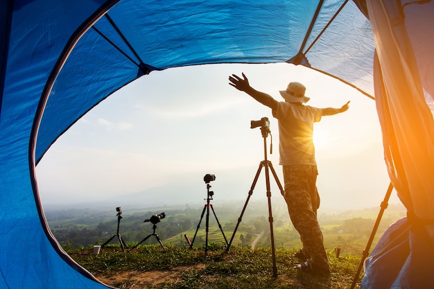 Camping tent in campground at the mountain with sunset,Sunset inside