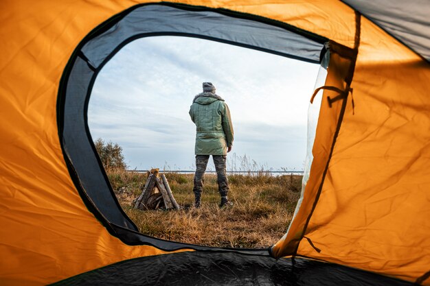 Camping view from the tent on the nature and man.  travel, tourism, camping.