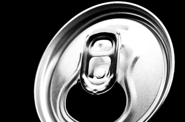 Can of fizzy drink on black background. Refreshing during summer heat. Vacations mood.