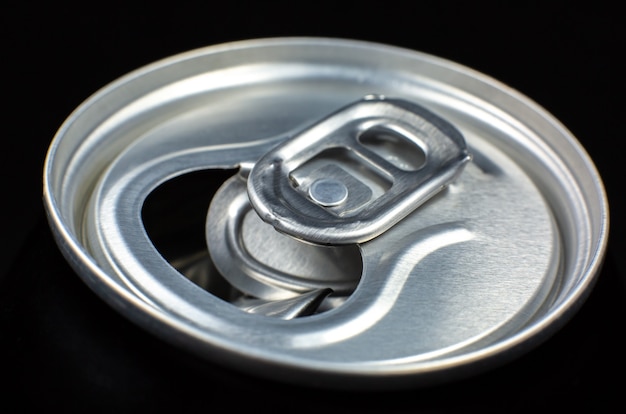 Can of fizzy drink on black background. Refreshing during summer heat. Vacations mood.