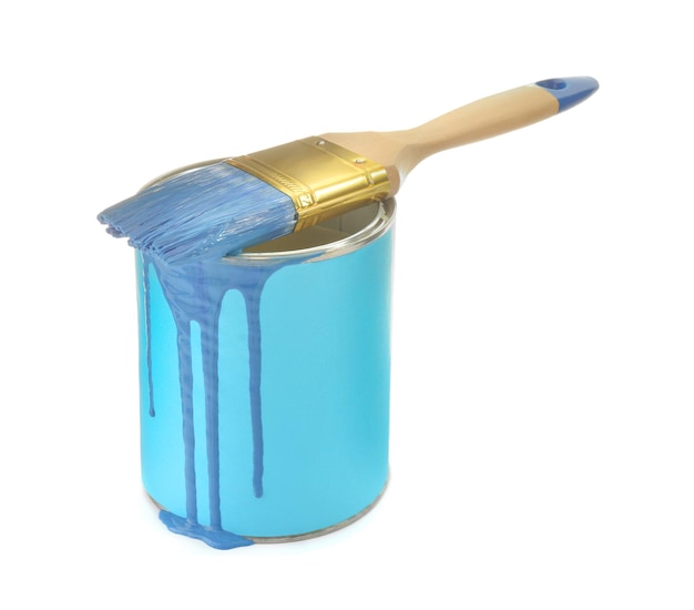 Can of light blue paint with brush on white background