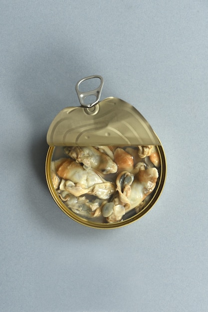 Can of razor shells on grey background