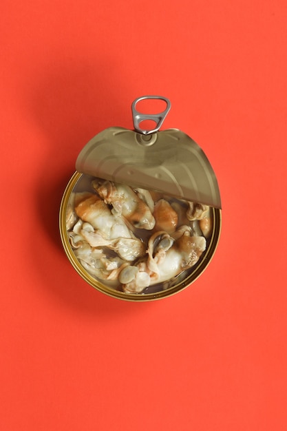 Can of razor shells on red background