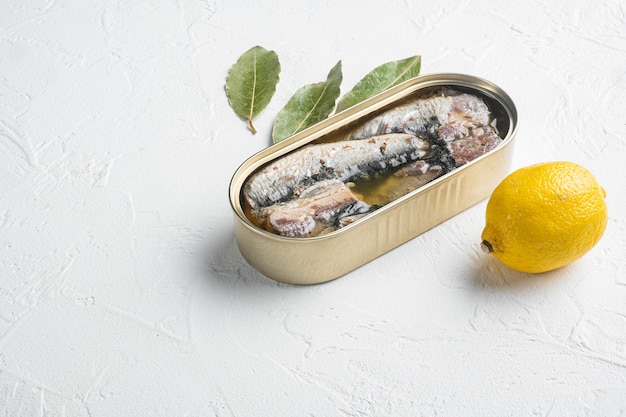 Can of sardines in olive oil set, on white stone table background, with copy space for text