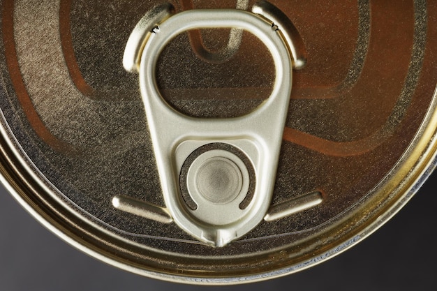 A can with a metal lid and a ring for opening