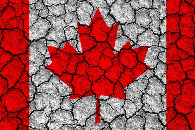 Canada flag on cracked wall dry ground