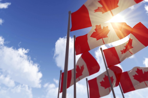 Canada flags waving in the wind against a blue sky d rendering