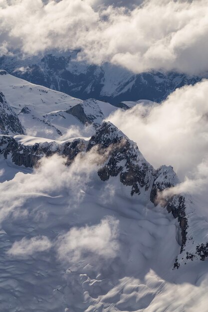 カナダの空中の険しい雪に覆われた山の風景の背景