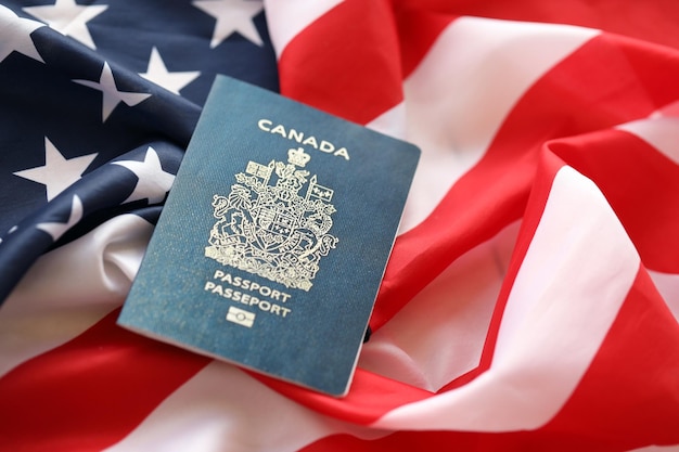 Canadian passport on united states national flag background close up tourism and diplomacy concept