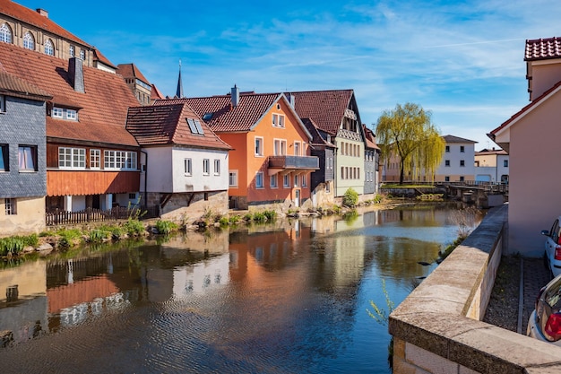 Canal amidst buildings in town against sky