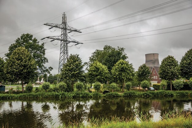 Photo canal and nuclear power plant near geertruidenberg a small village in the netherlands countryside