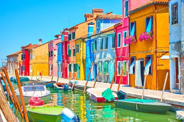 Canal with boats and picturesque houses in Burano, Venice, Italy