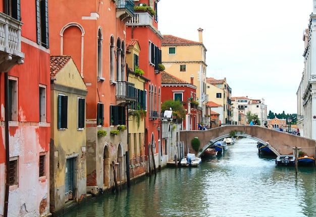 Canal with bridge in Venice, Italy. Architecture and landmark of Venice. Cozy cityscape of Venice.