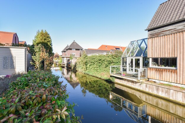 A canal with houses and a greenhouse on the water