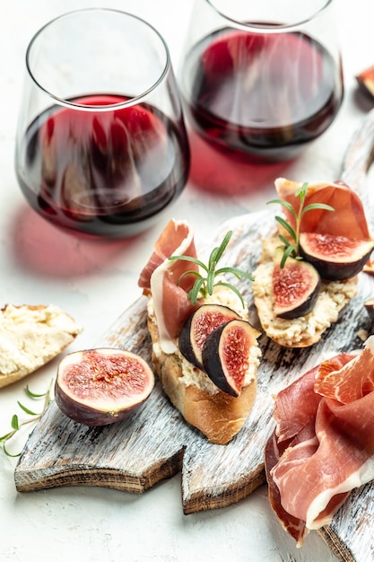 Canape or crostini with toasted baguette Fresh figs cream cheese and red wine Delicious appetizer ideal aperitif top view