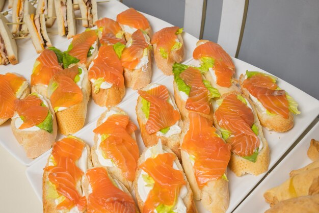 Canapes of fish bread cheese and herbs on skewers