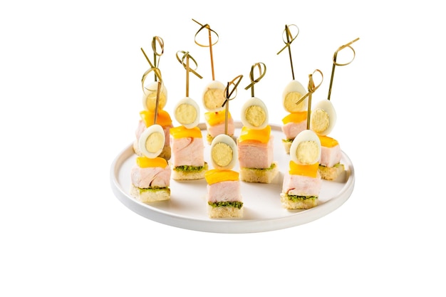 Photo canapes wish chicken breast cucumber yellow pepper eggs and white bread on plate