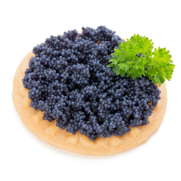 Canapes with black sturgeon caviar and  parsley. Isolated on the white background.